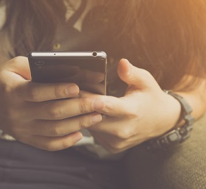 Teenager mit Smartphone in der Hand