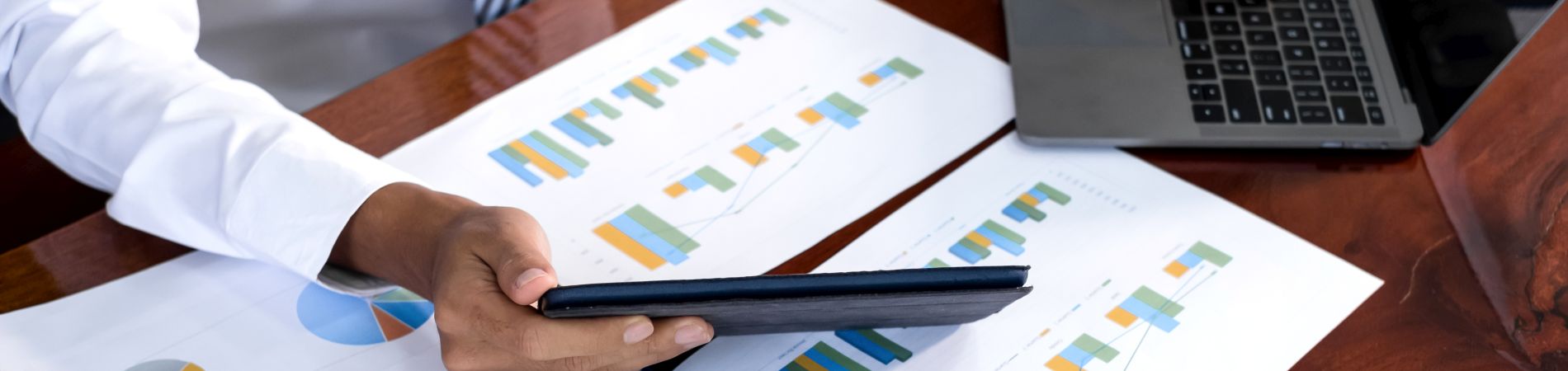 Unterlagen mit Abbildungen von Diagrammen und Statistiken auf dem Schreibtisch 